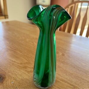 Emerald green Murano glass swung vase with swirling patterns.